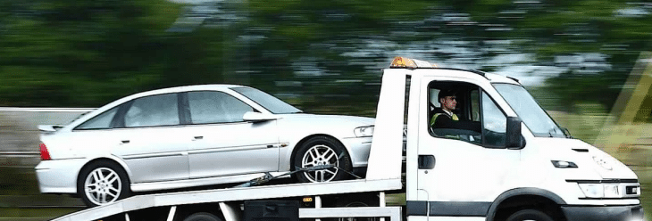 truck taking away a scrap car